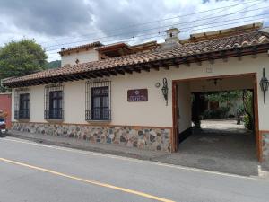 a building with an open door on a street at Hotel Posada San Felipe in Antigua Guatemala