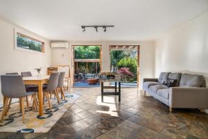 a living room with a table and a couch at The Panoramic Tree View Home in Melbourne City in Melbourne
