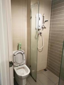 a small bathroom with a toilet and a shower at Kuching Kozi Square Apartment III in Kuching +13 photos