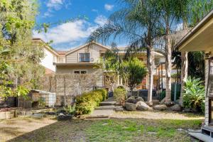 a house with a fence and a yard at The Panoramic Tree View Home in Melbourne City in Melbourne