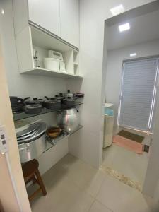 a kitchen with a stove and some dishes in it at Casa Jacuípe in Camaçari