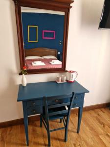 a blue desk with a mirror on top of it at Pepe's Place - Carlo Alberto in Rome