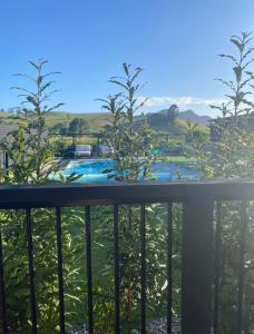 a view of a swimming pool from a balcony at Private by the beach in Whitianga