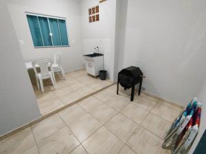 a room with a tiled floor with a table and chairs at Apto com jeito de casa entre o mar e a montanha in Florianópolis +26 photos