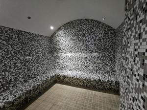 a room with a brick wall and a tile floor at PERFECT RESİDENCE TAKSİM, 2 BEDROOM, POOL, Gym, Sauna in Istanbul +36 photos