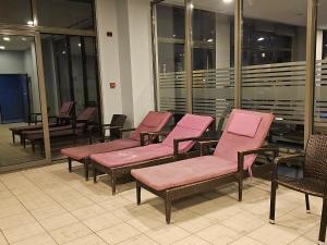 a row of chairs with pink seats in a building at PERFECT RESİDENCE TAKSİM, 2 BEDROOM, POOL, Gym, Sauna in Istanbul