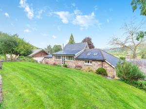 a house with a large lawn in front of it at The Coach House - Uk45027 in Gilwern