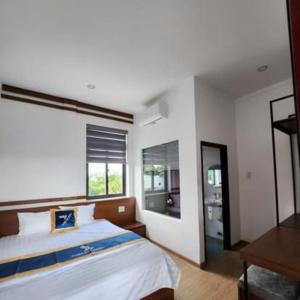 Un dormitorio con una cama grande y una ventana en THIÊN NGA HOTEL, en Buôn Alê (1)