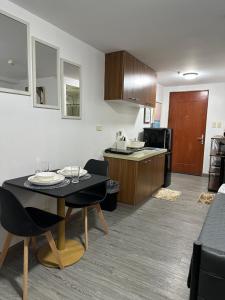 a kitchen and dining room with a table and chairs at Condo in Ortigas in Manila