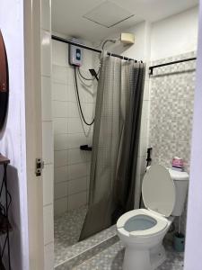 a bathroom with a toilet and a shower at Condo in Ortigas in Manila