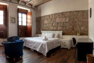 a bedroom with a bed with a teddy bear on it at Casa De Los Remedios Morelia in Morelia