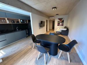 a dining room and living room with a table and chairs at Live Soho Boutique & Apartments Palermo Hollywood in Buenos Aires