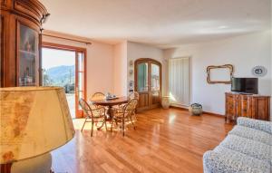 a living room with a table and chairs at Beautiful Home In Recco With Kitchen in Recco