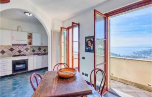 a kitchen with a table and chairs and a large window at Beautiful Home In Recco With Kitchen in Recco