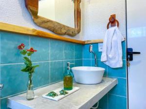 a bathroom with a sink and a bowl on a counter at Flat Pingo de Milagres in São Miguel dos Milagres