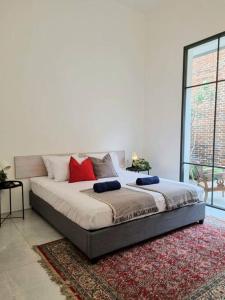 a bed with red pillows on it in a bedroom at Modern Brickhouse in Bandung +7 photos