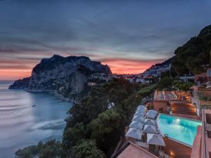 a view of the amalfi coast at dusk at Hotel Punta Tragara in Capri