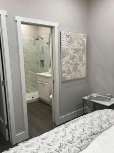 a bedroom with a bed and a bathroom with a mirror at 4048 Stylish condo in Hillcrest Mission Hills in San Diego