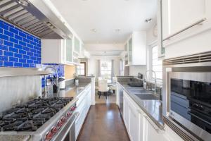a large kitchen with white cabinets and blue tiles at 4221 Urban oasis in Hillcrest Mission Hills in San Diego