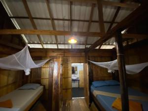 Postel nebo postele na pokoji v ubytování Robinson Bungalows