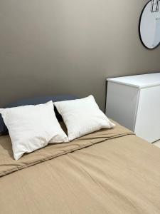 a bed with two pillows on top of it at Departamento Cristo del Portezuelo I in Chilecito