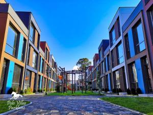 a cobblestone street in a city with buildings at Liana Polo Villas Parklane in Batumi
