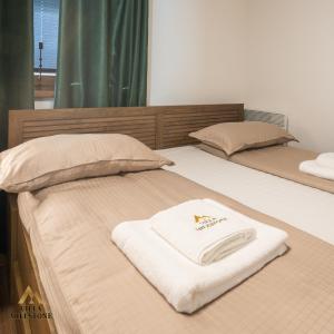 a bed with a white towel on top of it at Villa Milestone Majevica 
