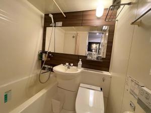a small bathroom with a toilet and a sink at APA Hotel Kitakami Ekinishi in Kitakami