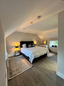 a bedroom with a large bed in a room at The Carthouse (Luxury 2 bed with private hot tub) in Newburgh