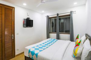 a bedroom with a bed and a tv on a wall at 79600 The Premium Villa in New Delhi