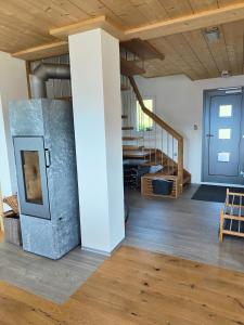 a living room with a blue door and a staircase at Chalet Matterhornsicht in Naters