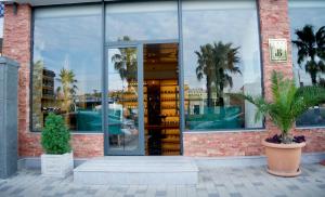a store front with glass doors and palm trees at Bessarion Boutique Hotel in Kutaisi