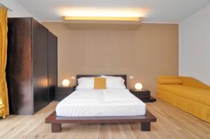 a bedroom with a bed and a couch at Eco Hotel Cleofe in Caorle