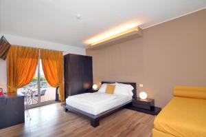 a bedroom with a bed and a balcony at Eco Hotel Cleofe in Caorle