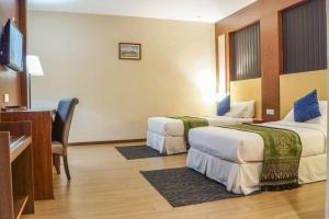 Postel nebo postele na pokoji v ubytování Hotel Pen Mutiara