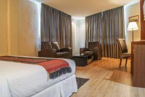Postel nebo postele na pokoji v ubytování Hotel Pen Mutiara