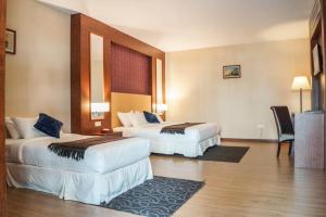 Postel nebo postele na pokoji v ubytování Hotel Pen Mutiara
