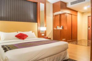 Postel nebo postele na pokoji v ubytování Hotel Pen Mutiara