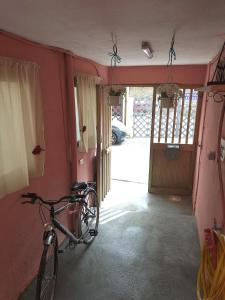 a bike is parked in a room with a house at Casa stella marina Villasimius.. in Villasimius