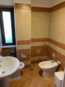 a bathroom with a sink and a toilet and a window at DOLCE DORMIRE in Albanella