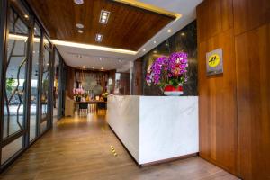 a lobby with a counter with a vase of flowers at Lealea Garden Hotels - Sun Lake in Yuchi