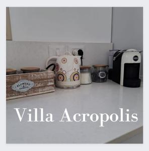 a kitchen counter top with a tea kettle and appliances at וילה אקרופוליס Villa Acropolis in ‘En Dor