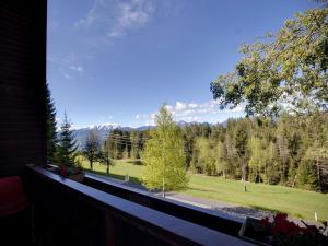 a balcony with a view of a field and trees at Apartment in Fresach near Millstättersee with pool in Fresach
