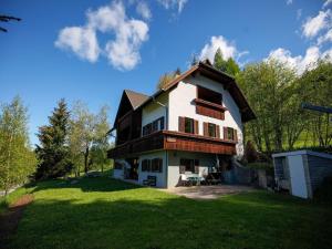 a large house on a grassy field with trees at Apartment in Fresach near Millstättersee with pool in Fresach