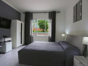 Un dormitorio con una cama grande y una ventana en 5 Swiss Hotel en Kigali