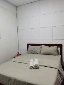 a bedroom with a bed with towels on it at Apartment in Ladang Tok Pelam - Hana Home by the Sea in Kuala Terengganu