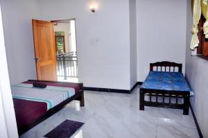 a room with a couch and a bench and a door at MALWATHTHA MOUNT VILLA KANDY in Kandy