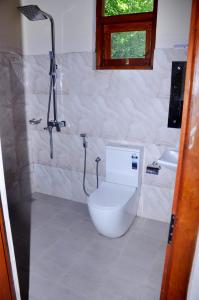 a bathroom with a toilet and a shower and a sink at MALWATHTHA MOUNT VILLA KANDY in Kandy