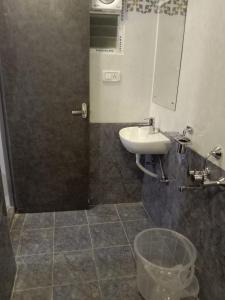 a bathroom with a sink and a mirror at HOTEL RAAJ GRAND in Chennai