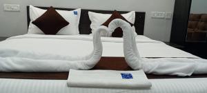 two swans made out of towels on a bed at HOTEL RAAJ GRAND in Chennai